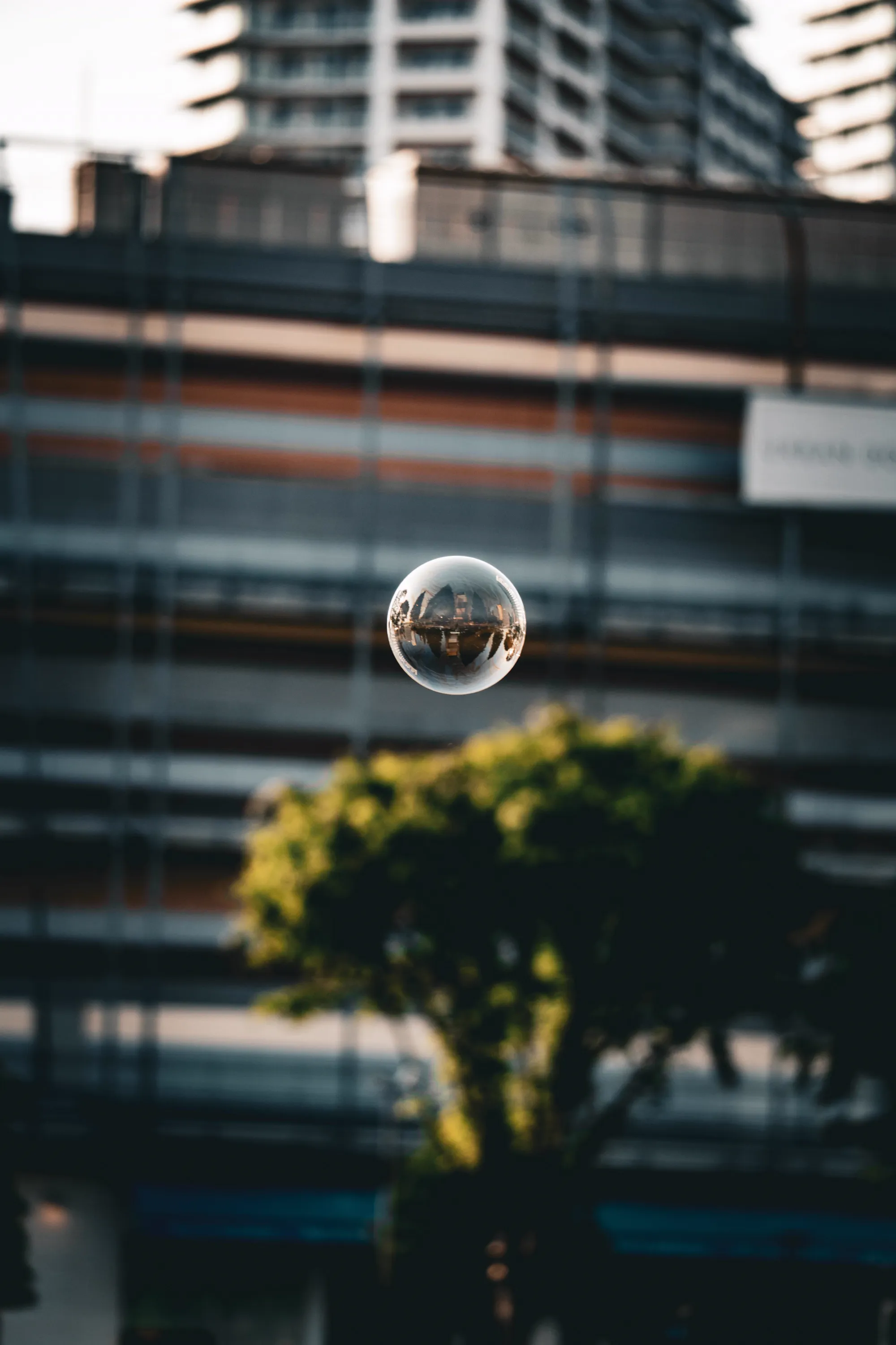 A floating soap bubble reflecting the city skyline upside down